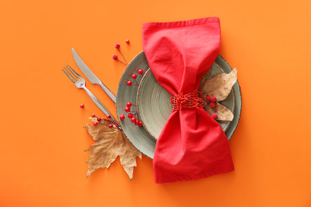 Autumn table setting on orange backgroundの写真素材