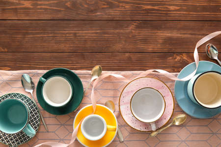 Set of stylish cups and spoons on wooden backgroundの写真素材