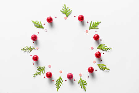 Beautiful Christmas wreath made of fir branches and balls on light background