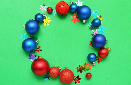 Frame made of Christmas decorations and confetti on green backgroundの写真素材