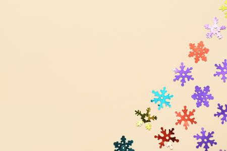 Beautiful confetti in shape of snowflakes on color backgroundの写真素材