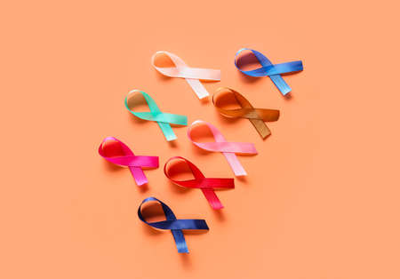 Different awareness ribbons on orange background. World Cancer Dayの写真素材