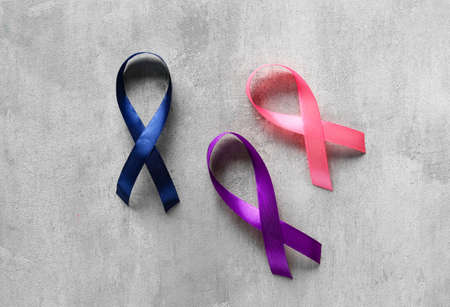 Different awareness ribbons on gray background. World Cancer Dayの写真素材