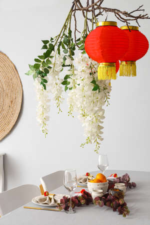 Beautiful table setting for Chinese New Year celebration in roomの写真素材