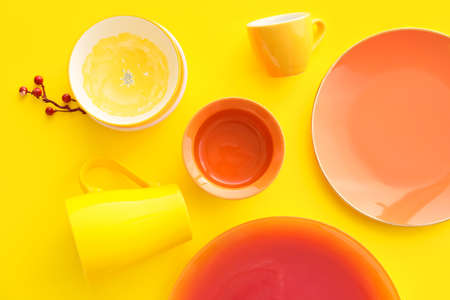 Set of stylish dinnerware on yellow backgroundの写真素材