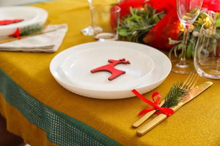 Dining table with setting for Christmas celebration indoorsの写真素材