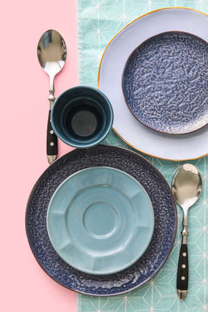Set of stylish dinnerware on pink backgroundの写真素材