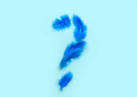 Question mark made of made of feathers on color backgroundの写真素材