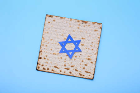 Jewish flatbread matza with David star for Passover on blue backgroundの写真素材