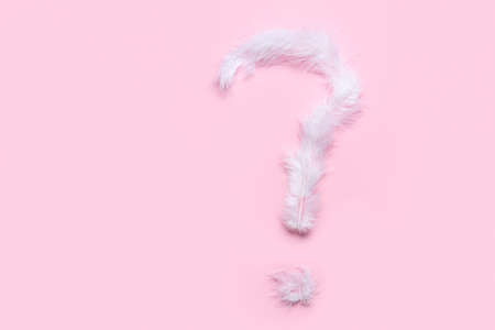 Question mark made of white feathers on pink backgroundの写真素材