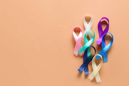 Different awareness ribbons on beige background. World Cancer Dayの写真素材