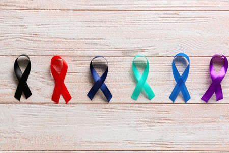 Different awareness ribbons on light wooden background. World Cancer Dayの写真素材
