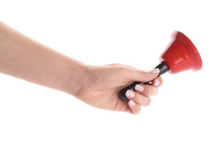 Female hand with red Christmas bell isolated on white background, closeup