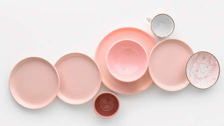 Set of stylish dinnerware on white background