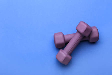 Stylish dumbbells on blue backgroundの写真素材