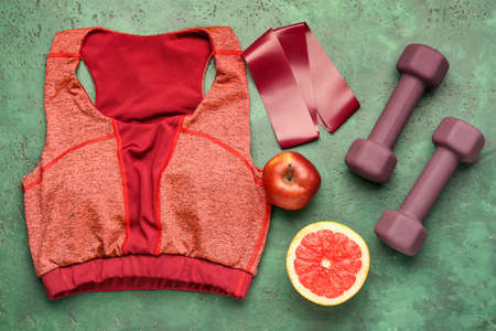 Stylish sport equipment and fruits on green backgroundの写真素材