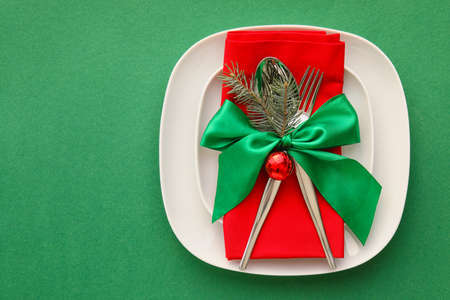 Beautiful Christmas table setting on green backgroundの写真素材