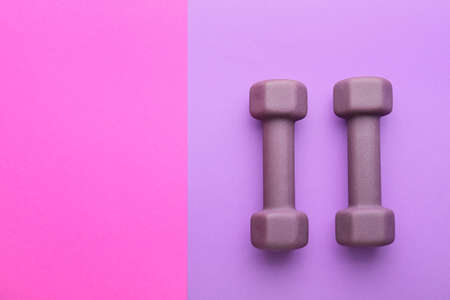 Stylish dumbbells on purple backgroundの写真素材