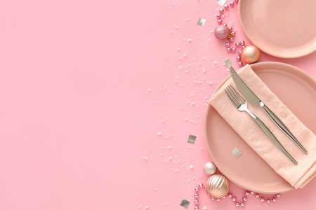 Beautiful Christmas table setting with decor on pink backgroundの写真素材