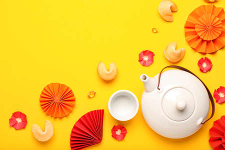 Teapot with Chinese symbols on color backgroundの写真素材