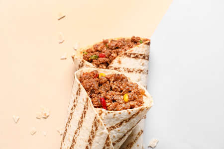 Tasty burritos on color backgroundの写真素材