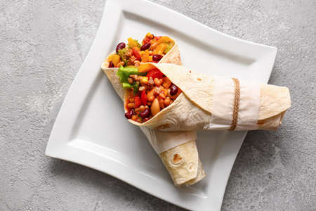 Plate with delicious burritos on gray backgroundの写真素材
