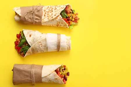 Delicious burritos on yellow backgroundの写真素材