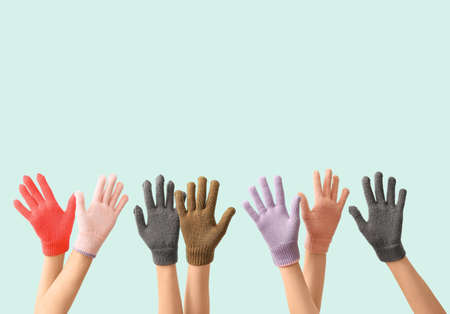 Women in warm gloves on blue backgroundの写真素材