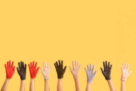 Women in warm gloves on color background