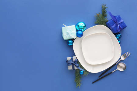 Beautiful Christmas table setting with decor on blue backgroundの写真素材