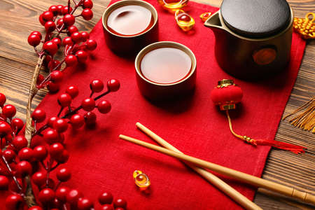 Tasty Chinese tea with chopsticks on wooden backgroundの写真素材
