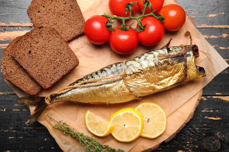 Tasty smoked mackerel with bread on table