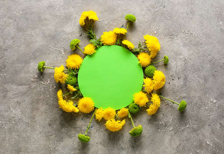 Composition with blank card and beautiful chrysanthemum flowers on grunge backgroundの写真素材