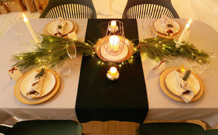 Dining table with setting for Christmas celebration indoors