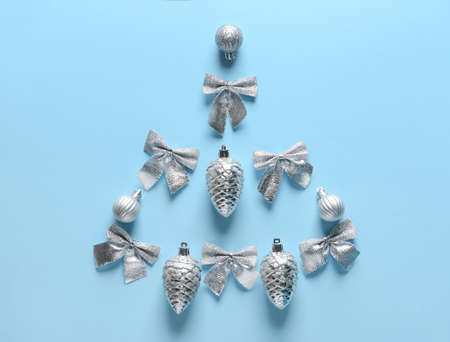 Christmas tree made of silver decor on blue background