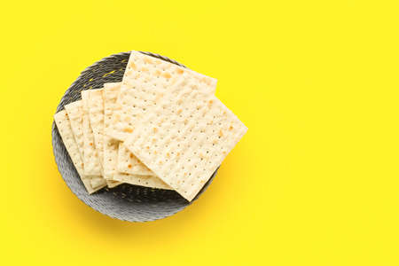 Basket with Jewish flatbread matza for Passover on yellow backgroundの写真素材