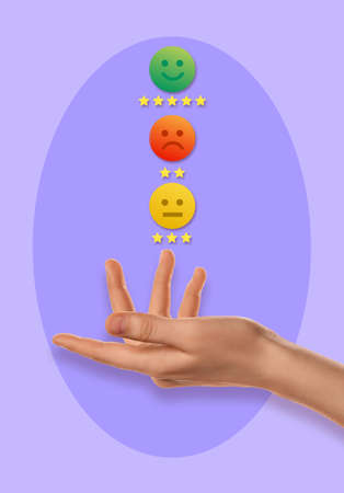 Female hand and different emoticons on lilac backgroundの写真素材