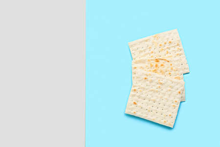 Jewish flatbread matza for Passover on gray and blue background