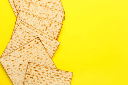 Jewish flatbread matza for Passover on yellow backgroundの写真素材