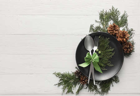 Beautiful Christmas table setting with decor on light wooden backgroundの写真素材