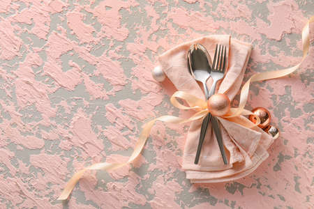 Beautiful cutlery with Christmas decor on pink grunge backgroundの写真素材