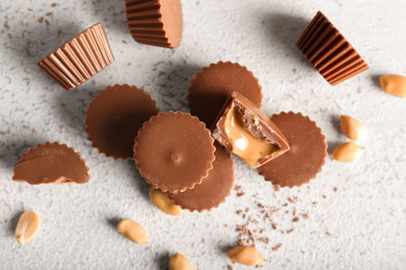 Tasty peanut butter cups on light backgroundの写真素材