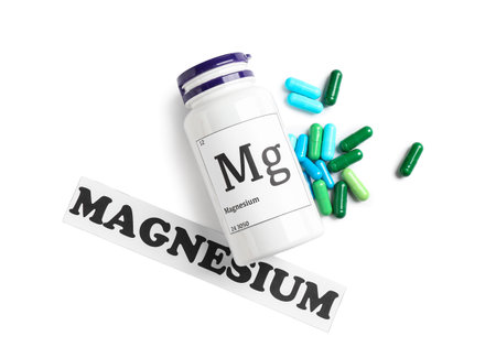 Bottle of pills and word MAGNESIUM on white backgroundの写真素材