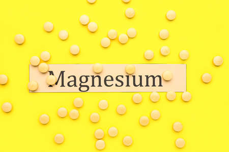 Many pills and word Magnesium on yellow backgroundの写真素材