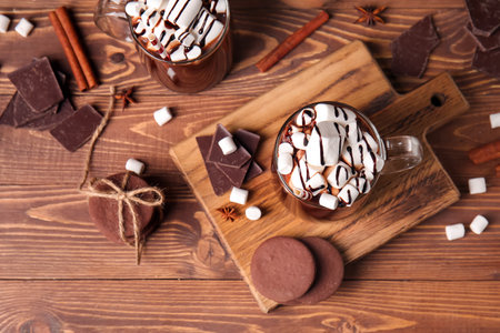 Glass cups of tasty hot chocolate on wooden backgroundの写真素材