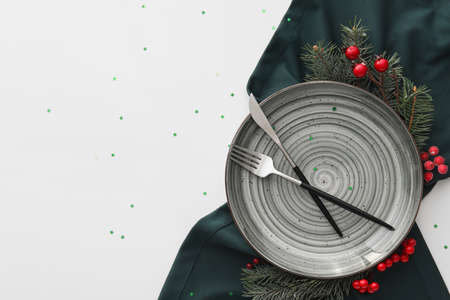 Beautiful Christmas table setting with decor on white backgroundの写真素材