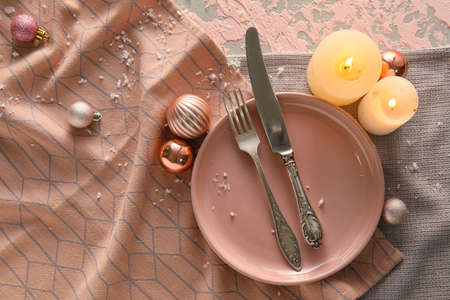 Beautiful Christmas table setting with decor on pink grunge backgroundの写真素材
