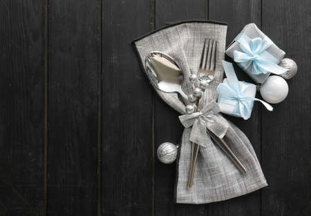 Beautiful cutlery with Christmas decor on dark wooden backgroundの写真素材