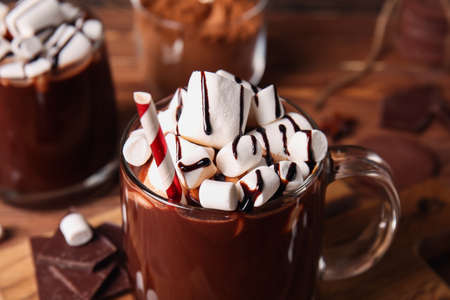 Glass cups of tasty hot chocolate on wooden background, closeupの写真素材