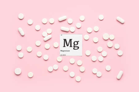 Magnesium pills on pink background